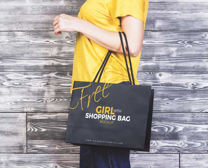 Girl-With-Shopping-Bag-MockUp-Freebie-on-Antique-Wooden-Background